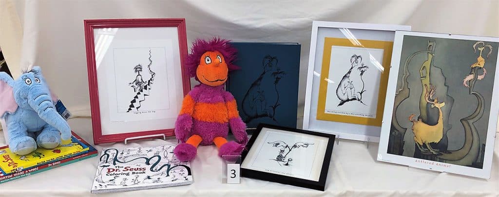 Dr. Seuss plush dolls, books and pictures in frames.