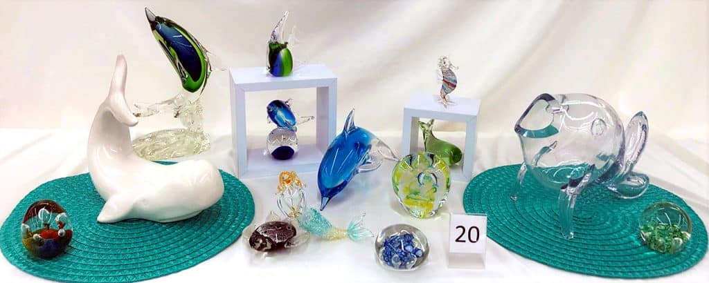 Glass dolphins, whales and other sea themed glass.