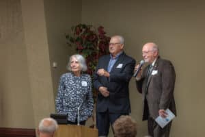 Servants of the Poor Banquet 6 Three participants at the front of the room during a recognition moment at the 2026 Servants of the Poor Banquet