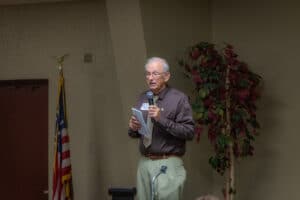 Servants of the Poor Banquet 3 Speaker addressing banquet attendees with a handheld microphone